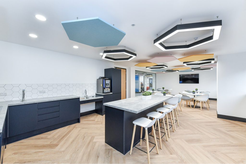 Office kitchen and dining area with modern lighting on Interface carpet tile